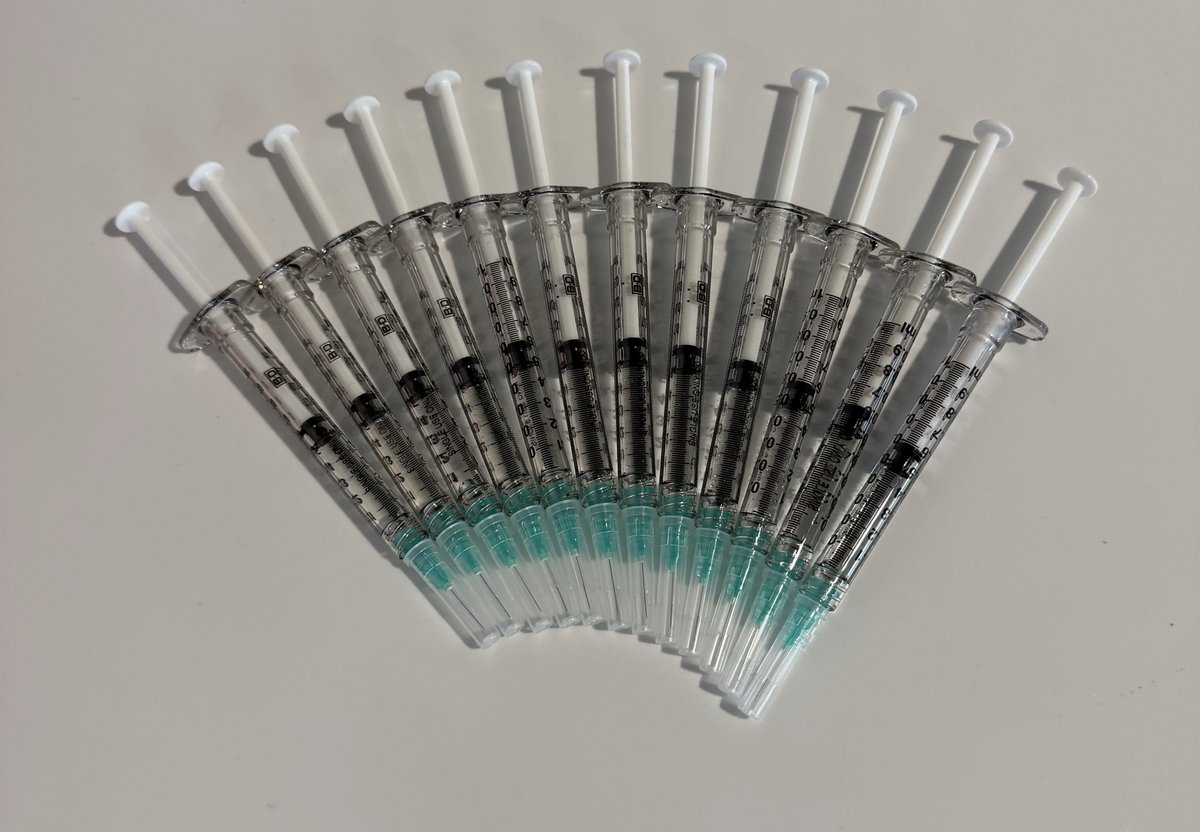 Twelve NAD+ injections fanned out on a white table